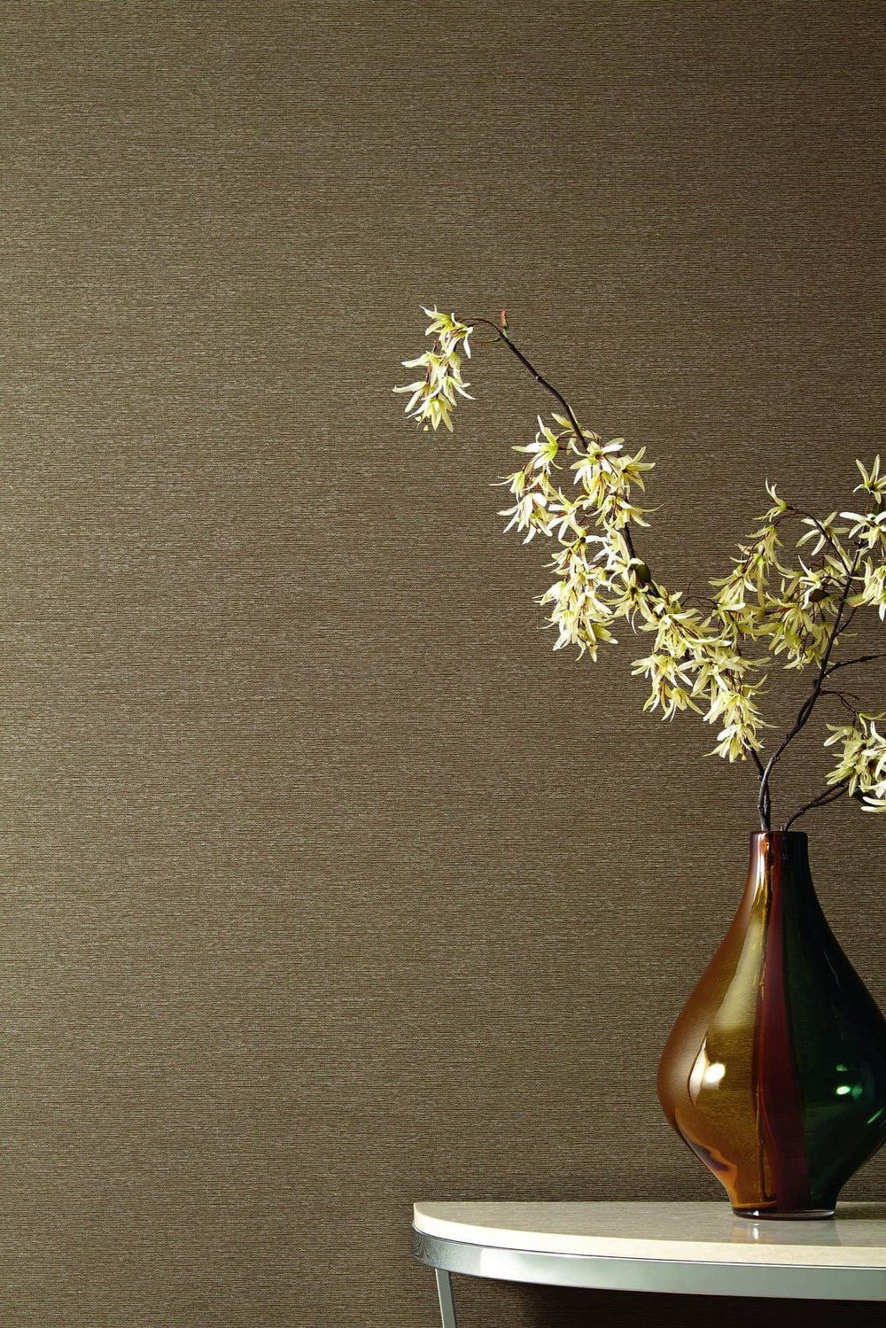 Decorative vase on table showcasing textured wallcovering