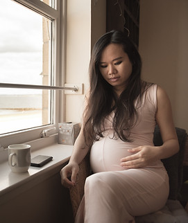 Thinking pregnant woman with a nice belly touch