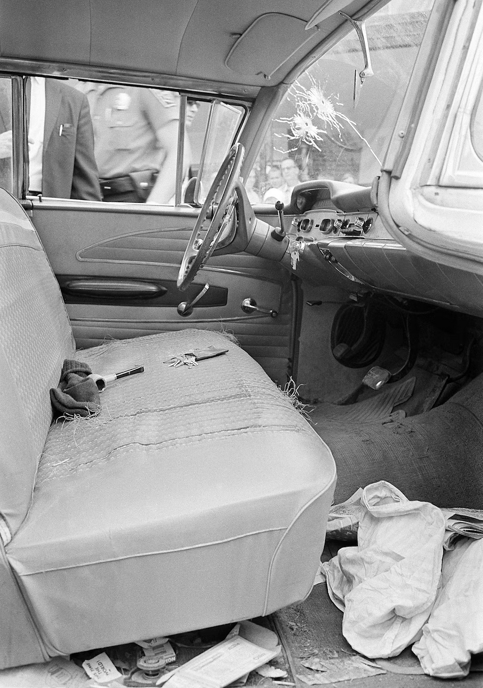 Dirty vintage car interior with stained passenger seat and debris.