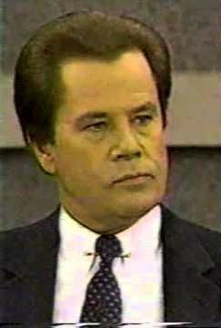 Television still of evangelist John Wesley Fletcher in a dark suit and spotted tie