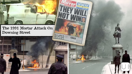Burning van and smoke on street during 1991 Downing Street attack. Policemen in foreground. Newspaper headline: "They Will Not Win."