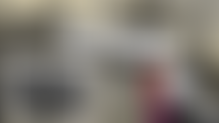 Historical photo of three men standing in front of a brick wall. Background shows Auschwitz gate with text: "Rudolf Höss: The Commandant..."