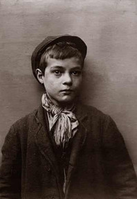 Sepia-toned portrait of a serious young boy wearing a cap and scarf.