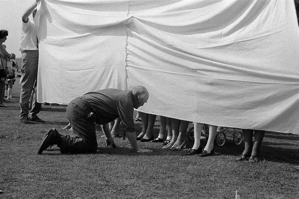 Marhamchurch, Cornwall (1970) The village revel is held annually on the Monday following 12th of August. The Queen of the Revel is chosen from the village schoolgirls and crowned by Father Time in front of the church where St. Morwenna is thought to have founded her hermitage at the end of the fifth century. Led by the local band and the newly crowned Revel Queen, a procession moved through the village to the Revel Ground, where the prettiest ankles competition took place.