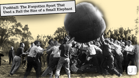 Crowd of men push a giant ball in an outdoor black-and-white pushball game; banner reads Pushball: The Forgotten Sport That Used a Ball the Size of a Small Elephant