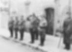Dirlewanger (right) standing next to a group of officials at a Nazi parade near Kielmeyerhaus, Germany, in December 1943. Dirlewanger was still recuperating from a gunshot wound to his chest, received during anti-partisan operations in Belarus, explaining why he is holding a cane and saluting with his left arm.