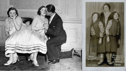 Two women in matching dresses sit close; a man kneels and kisses one woman's cheek. Elegant room with patterned floor; 1920s vibe.