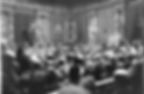 A crowded courtroom with officials seated at a long table. People observe, and large charts are displayed. Ornate columns and drapes set the scene.