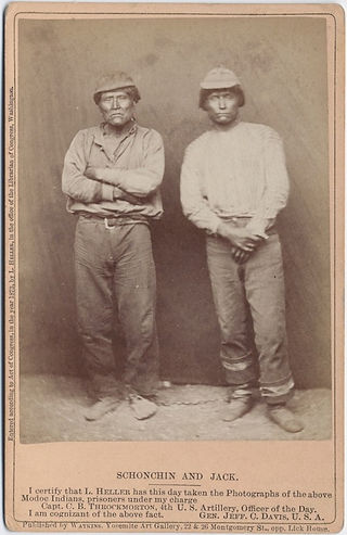 Two Native American men in simple clothing, standing, historical portrait.