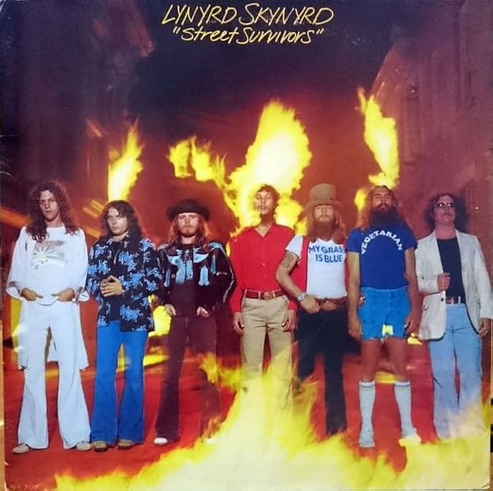 Seven men stand confidently in front of flames. Text above reads "Lynyrd Skynyrd 'Street Survivors.'" Bright colors and 70s attire.