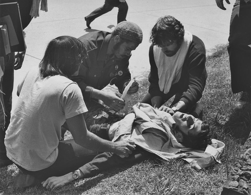 Students help John Cleary, who had been shot by the National Guard.
