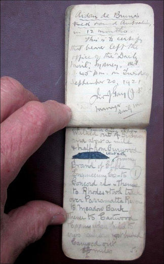 Hand holds two aged handwritten cards displaying 'September 20, 1937' text.