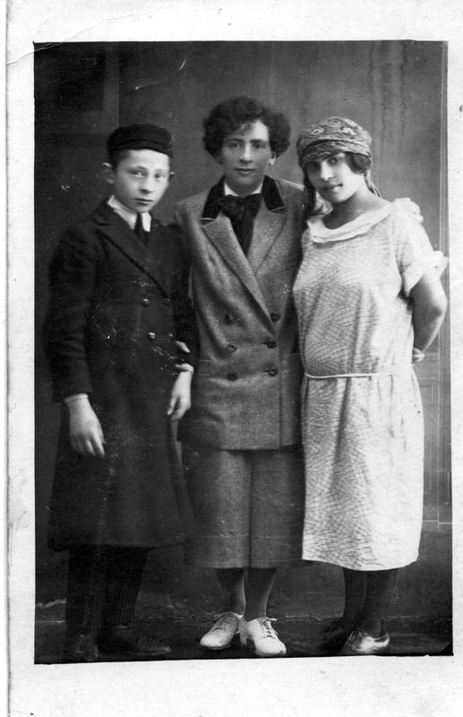 Vintage photograph showing young boy and two women posing together.