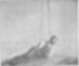 Man lying on a mat holding a rope, wearing a vest and tie. The background is plain, creating a vintage, calm setting. No visible text.