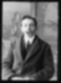 Man in a suit with a furry tongue, sitting indoors against a blurred backdrop. The image is in black and white, creating a surreal effect.
