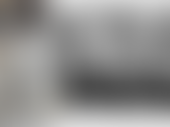 wo dressed men stand outside a building. Nearby, four chained individuals sit indoors. Text: "Chained Indian rubber gatherers."