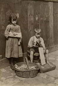 Two young children, a girl and boy, working with wood and tools.