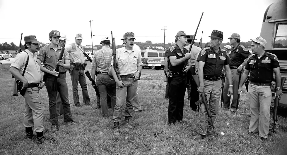 Officers gather near Locust Grove while searching for a suspect in the Camp Scott girl scout murders.