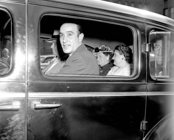 Raymond Fernandez looks from car window with Martha Beck inside.