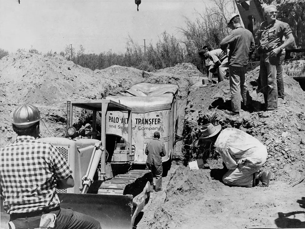 Workers unearth the buried kidnap van where 27 people were held hostage. The weight of dirt crushed the top