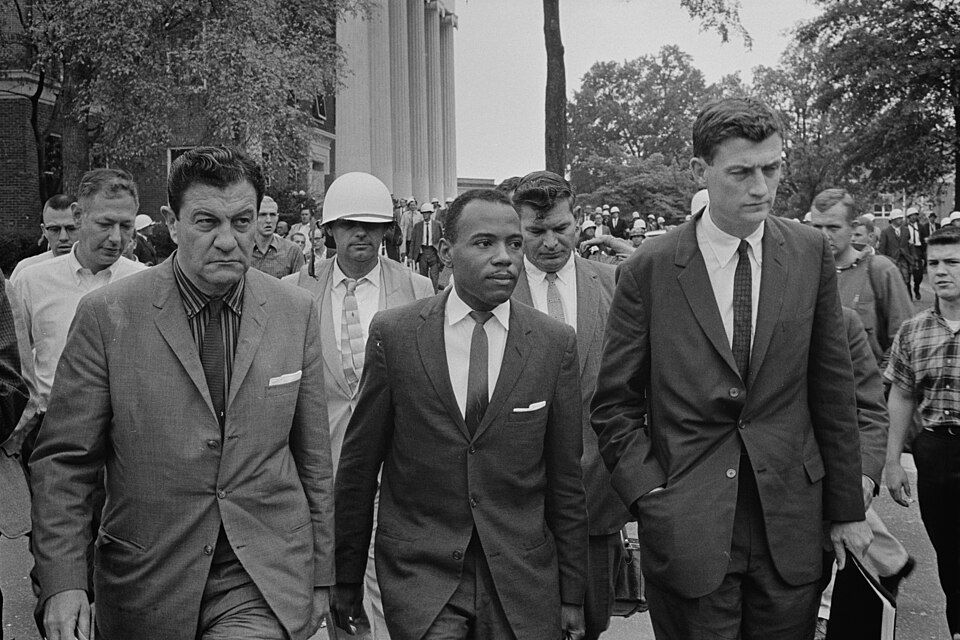 Chief U.S. Marshal James McShane (left) and U.S. Assistant Attorney General for Civil Rights John Doar (right), escorting James Meredith (center) to class at Ole Miss after the riot.