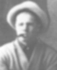 A person in a hat and sweater holds a cigar in their mouth. The black-and-white setting gives a vintage feel, with a neutral expression.