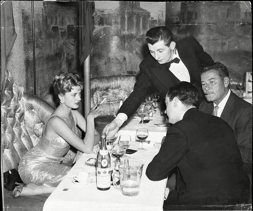 A nearly 50 year old Errol Flynn pictured with his 16 year old girlfriend, Beverley Aadland at The Lido Nightclub on Swallow Street, just off Piccadilly, 5th May, 1959