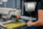 Operator working with footwear production machinery at Abucombal