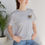 Thumbnail: Woman in light grey Moshipco t-shirt
