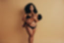 Plus size woman breastfeeding her infant. Mother with baby in hands standing and breastfee