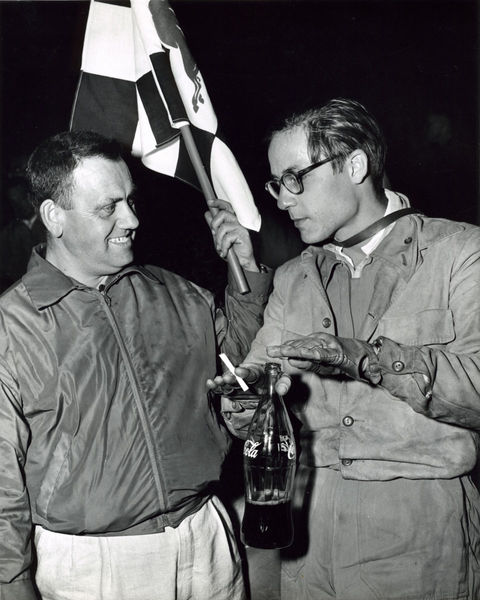 Following the victory over Ernie McAfee Masten in victory describes to Tony how he fended of Ernie McAfee as Tony smiles holding the checkered flag, December 4, 1955.

Photo: Parravano Family Collection