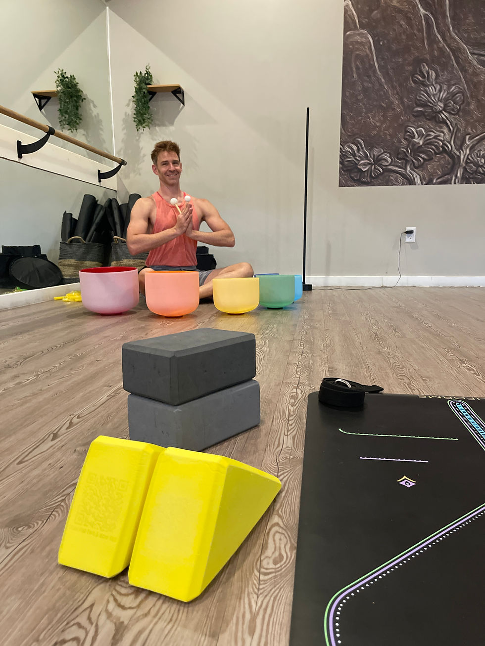 Close-up view of a wooden yoga triangle on a yoga mat