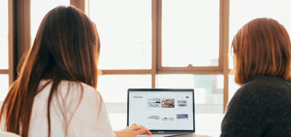 two-women-talking-while-looking-at-laptop-computer.jpg