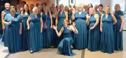 Group photo of the Abbey Belles after performing on stage at LABBS in Harrogate
