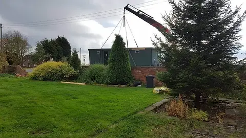 The Toilet Block is Moved into Place