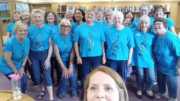 Abbey Belles have a photo taken, before singing to an appriciative audience
