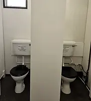 Mens clean toilets in a warm toilet block