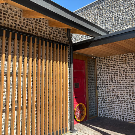 Iroko timber brise-soleil at entrance of contemporary home