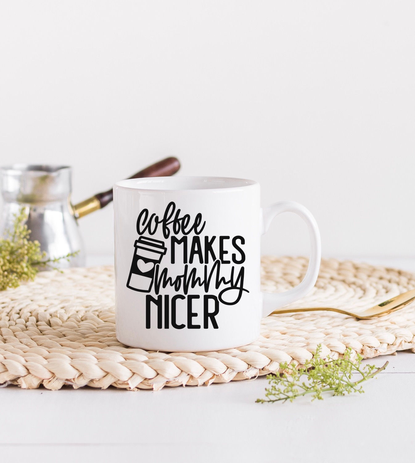 White mug reads: Coffee Makes Mornings Nicer