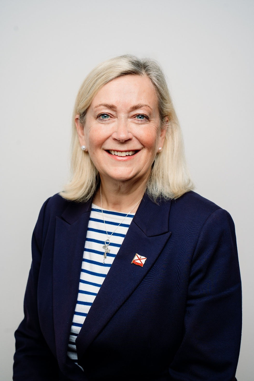 Helen Miles' official photo wearing a Jersey flag pin on her lapel.