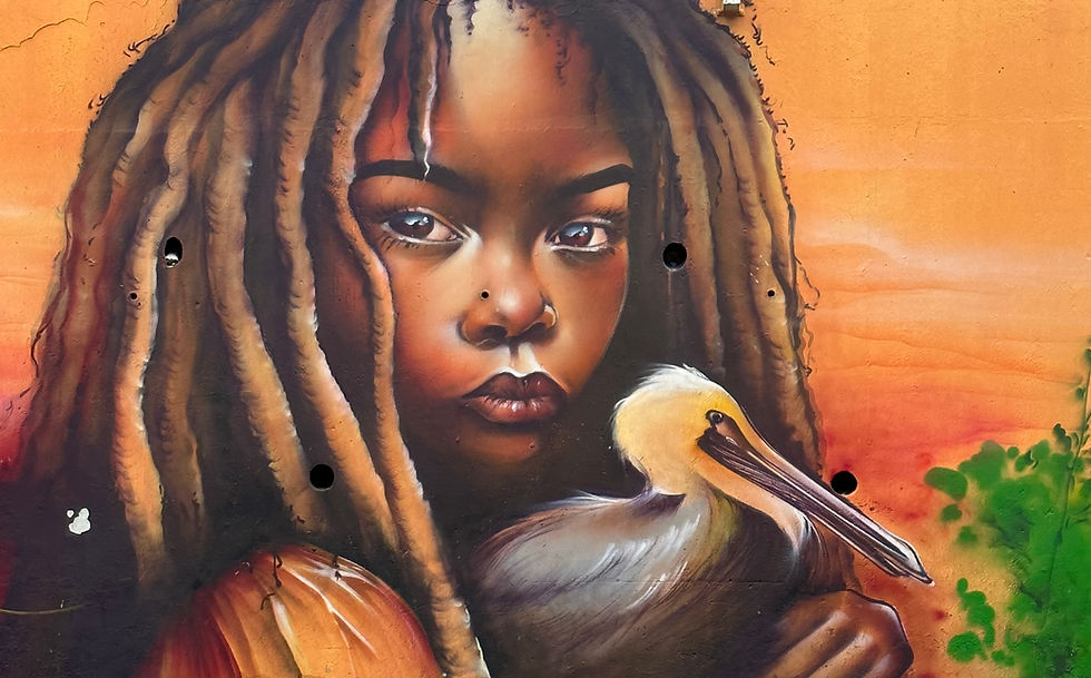Fresque-murale-femme-aux-dreadlocks-et-pélican-Le-Gosier-Guadeloupe-voyagez-en-toute-légèr