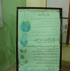 Poster with Urdu text and illustrations about water conservation, on a display stand.