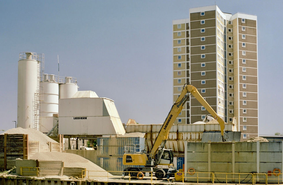 An industrial scene with residential block behind it