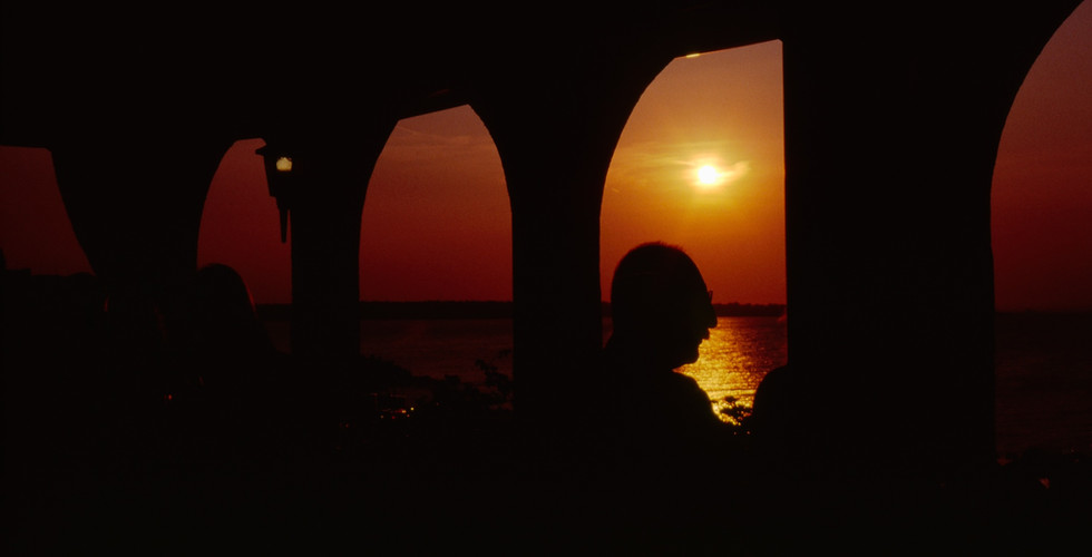 Sunset Dinner - shot directly into the sun with a silhouette of people eating dinner.