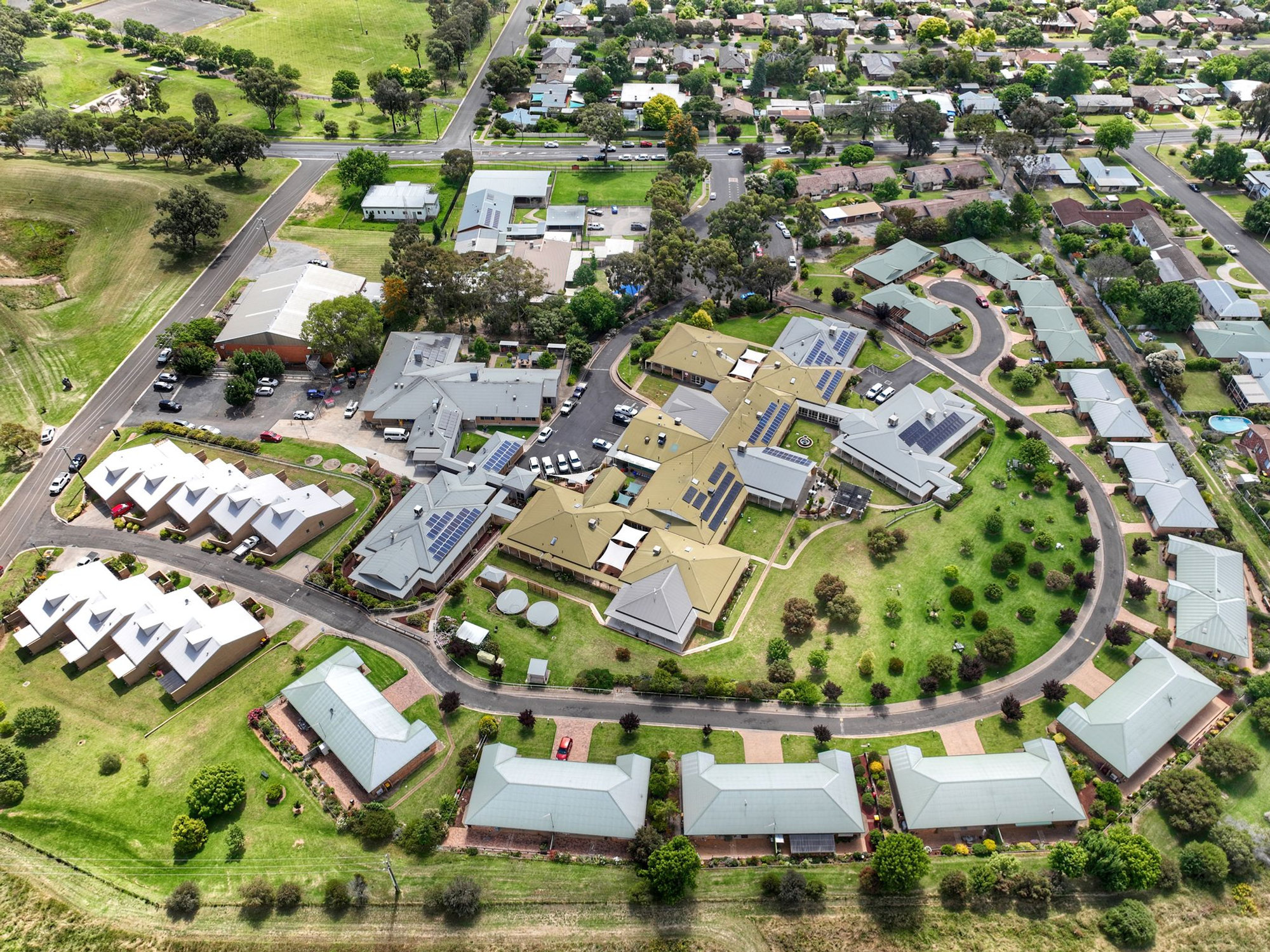 Aerial view of Cowra Retirement Village, with the residential care home in the centre and independent living units around the ring road