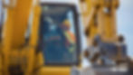 Two workers in hard hats and safety vests operate a yellow excavator under a clear sky. Focus on teamwork and machinery details.