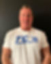 Smiling man in TC's Training Center shirt