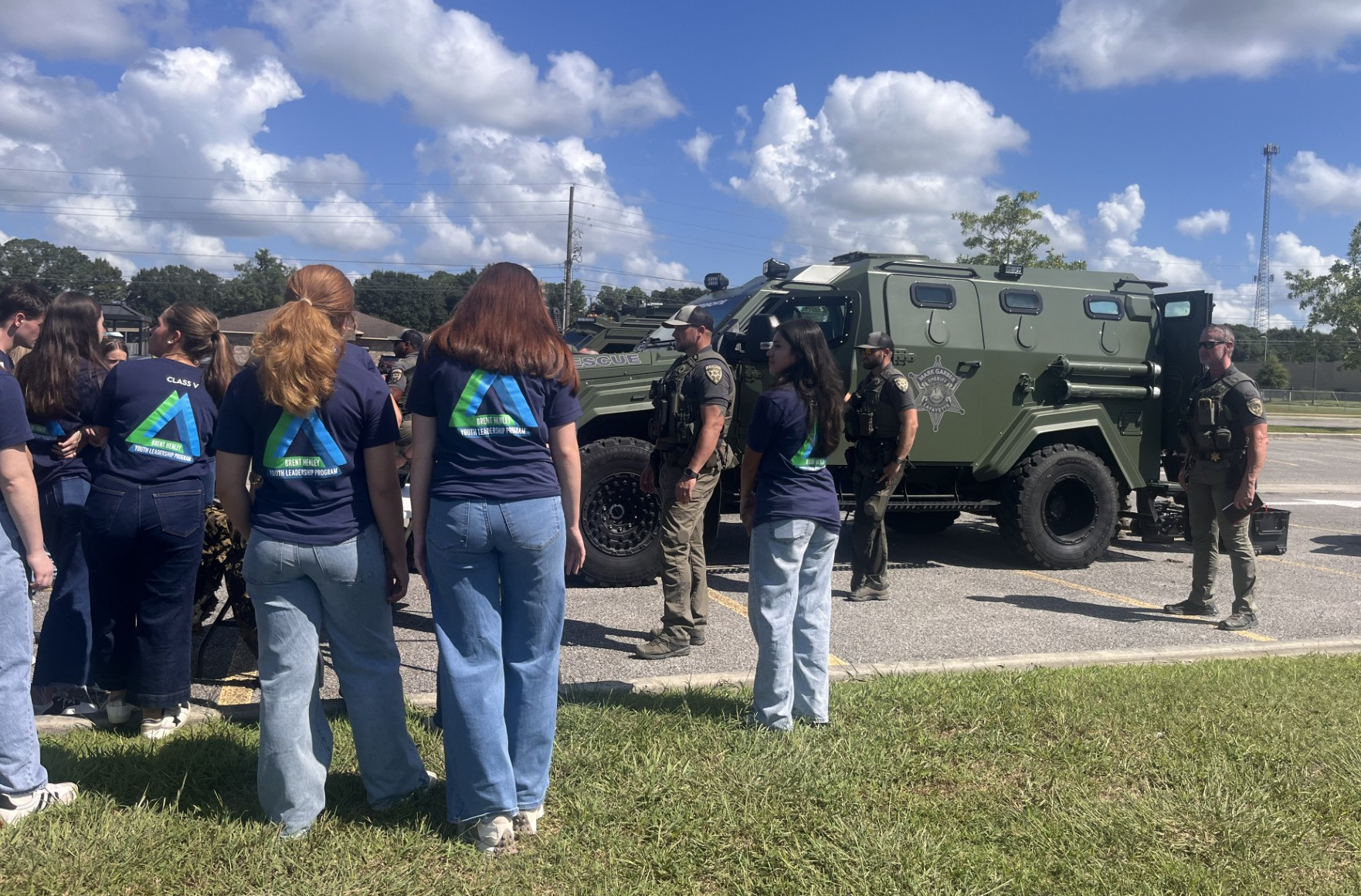 Close-up view of students looking at a SWAT vehicle during a safety demonstration.