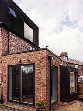 A view to the angled window seat and modern dormer extension to a property in Chorlton, designed by Manchester architects, Mulholland Architecture