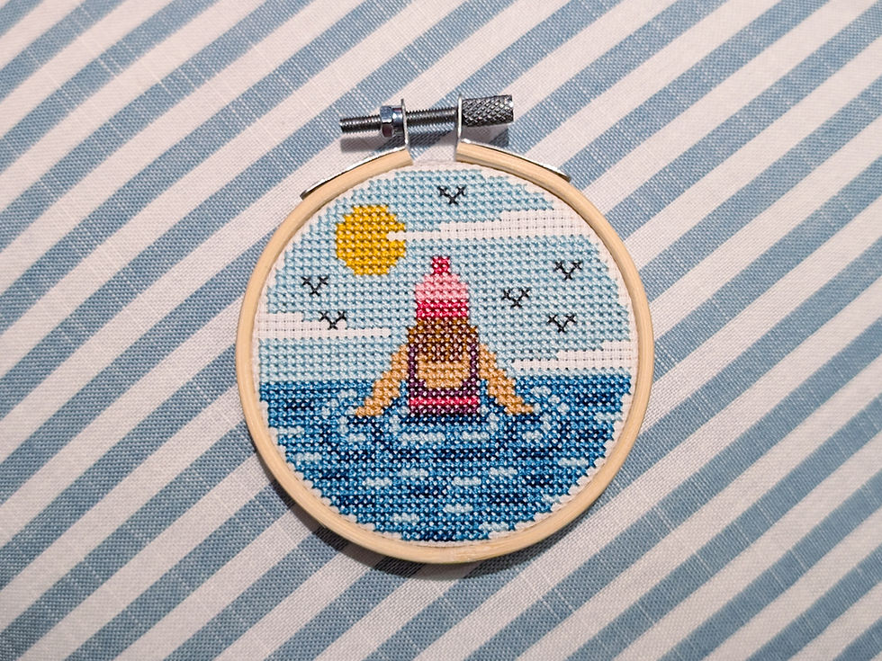free cross stitch pattern of sea swimmer in sea with birds, sun and clouds in the sky
